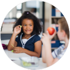Photo of children eating healthy food together in the school cafeteria